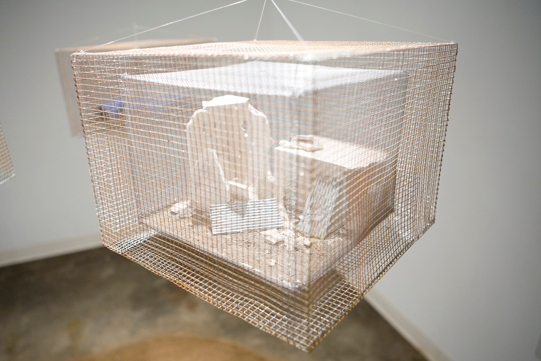 Far from Home Palestinian refugee camp detail, a mixed-media miniature structure enclosed in wire mesh